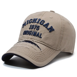 Retro distressed khaki baseball cap with blue Michigan embroidery in a 45-degree angle view