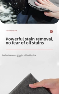 Macro view of thick microfiber cleaning cloth removing stains on a glossy surface
