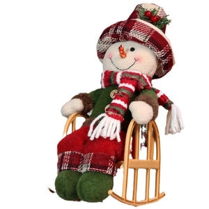 Christmas snowman plush doll sitting in a red plaid rocking chair for holiday decoration