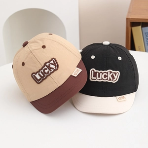 Detailed close-up of quick-dry baseball caps with Lucky embroidery and soft cotton texture