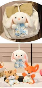 Detail of plush animal pendants with floral outfits hanging on a canvas bag