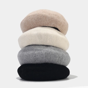 Stacked angora wool berets in camel, beige, grey, and black for autumn and winter