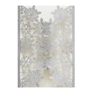 Macro detail of laser-cut silver glitter snowflake invitation card with hollow pattern