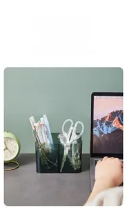 Close-up of green transparent acrylic desktop organizer with dual compartments