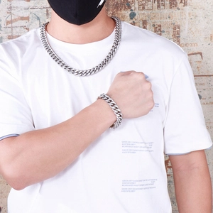 Iced out silver Cuban link chain necklace and bracelet set on streetwear model