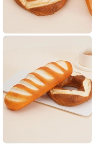 Realistic artificial pretzel and baguette bread model displayed on a white plate