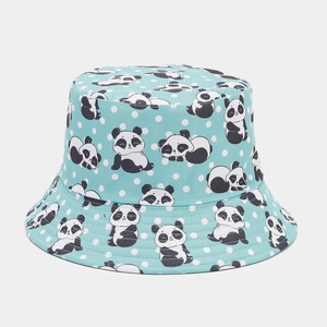 Close-up of light blue reversible bucket hat with cute cartoon panda and polka dot patterns