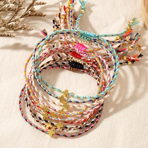 Handmade woven cross charm bracelets set with adjustable sliding knots in bohemian style