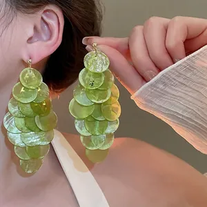Elegant gold drop earrings with tiered translucent green shell discs for women