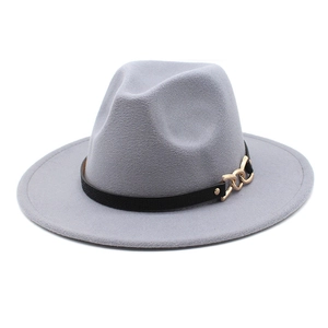 Detail of wide brim grey fedora hat with black leather band and gold chain buckle