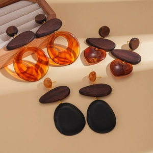 Three pairs of retro resin and wood earrings in circle, heart, and teardrop shapes