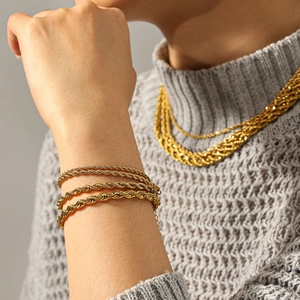 Close-up of 18k gold-plated stainless steel rope chain necklace and multi-layer bracelet