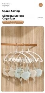 Detail of white wave-shaped hanger with anti-slip multi-hook design for innerwear