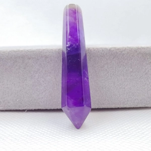 Deep purple hexagonal crystal prism pendant displayed on a vertical velvet stand