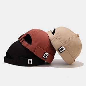 Three retro canvas miki hats in black, red, and khaki with R letter patch detail