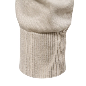 Close-up of beige men's crewneck sweater featuring premium ribbed knit cuffs and texture