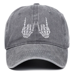 Close-up of high-quality white skeleton hand embroidery on a washed dark gray cotton cap