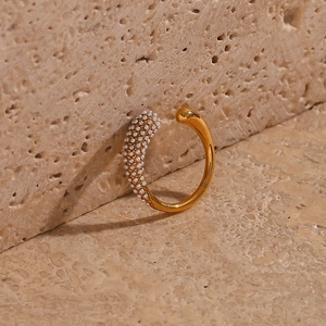 Golden stainless steel open ring featuring a smooth teardrop and pavé pearl detail