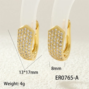 Macro shot of gold U-shaped hoop earrings with micro-pave zircons, 13x17mm size