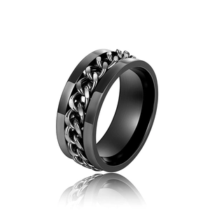 Macro shot of a black stainless steel spinner ring with rotating Cuban chain detail