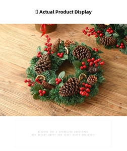 Detailed close-up of Christmas wreath with pine needles, pine cones and red berries on wood