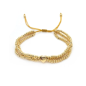 Three-layer 18K gold-plated beaded bracelet featuring a polished heart pendant and drawstrings