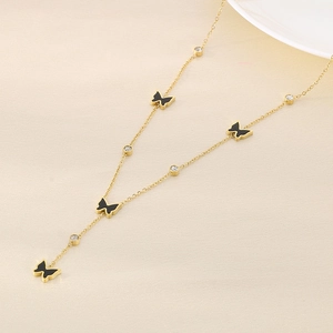 Detail of gold necklace with black butterfly charms and sparkling zircon accents
