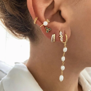 Gold stud earrings set with marquise zircon and butterfly pearl drop on ear model