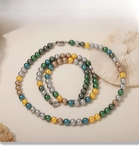 Macro shot of 8mm multi-color faux pearl necklace and bracelet set with PVD plating