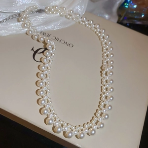 Close-up of double-layer gradient white pearl necklace with adjustable metal chain
