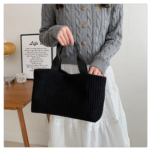 Minimalist black corduroy tote bag for women featuring a large capacity bucket style design