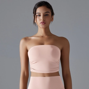 Detail of pink ruched sports tube top showing breathable fabric and slimming side folds