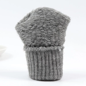 Detail of dark grey cable knit winter fingerless gloves with ribbed cuffs for warmth