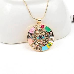 Bohemian gold necklace featuring evil eye, hamsa hand, and clover charms with zircons