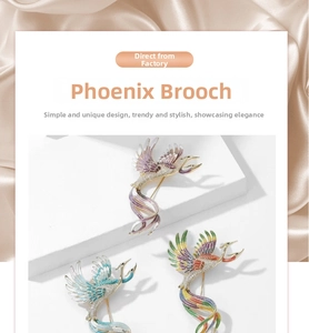 Detail of colorful phoenix enamel brooches with crystals on silk background