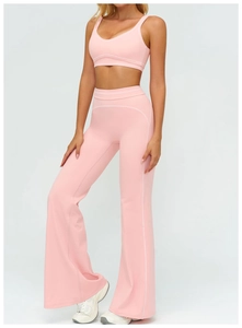 Pink high-waisted flared yoga pants and sports bra set with white contrast piping details
