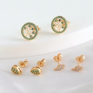 Elegant gold plated stud earrings set with green zircon and lightning tree designs