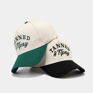 Two-tone baseball caps with TANNED & Tipsy letter embroidery in green and black