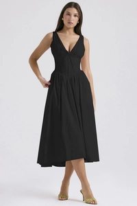 Close-up of a slim-fit black V-neck maxi dress featuring a cinched waist and pleated skirt
