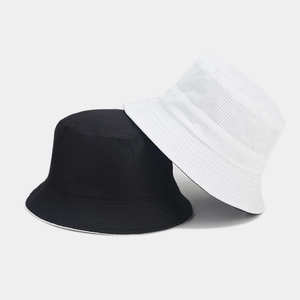 Detail showing high-quality corduroy texture and stitching on black and white bucket hats