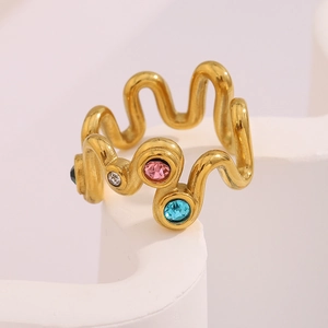 Macro shot of 18K gold plated wavy ring featuring vibrant multi-color crystals