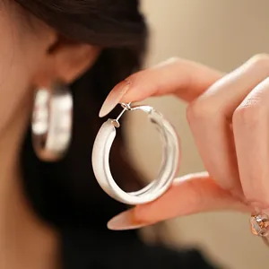 Matte silver brushed thick hoop earrings with large circular minimalist design for women