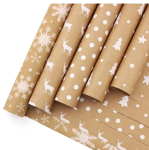 Detail view of brown kraft Christmas wrapping paper rolls with white reindeer and tree prints