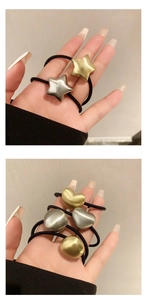 Detailed view of metallic hair ties with brushed gold and silver geometric charms