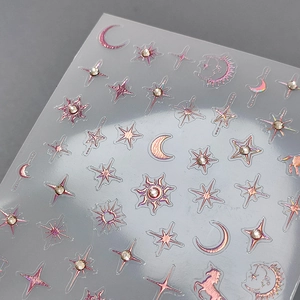 Rose gold 3D embossed nail stickers with stars, moon, and unicorn patterns with rhinestones
