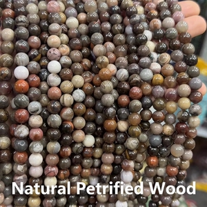Macro detail of polished natural petrified wood round beads for DIY jewelry making
