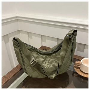 Olive green quilted dumpling crossbody bag with adjustable wide shoulder strap