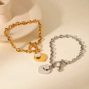 Detail of OT buckle heart pendant bracelet with gold and silver chains and rhinestones