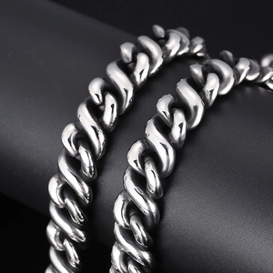 Macro shot of polished silver Cuban link chain necklace with high quality metal texture