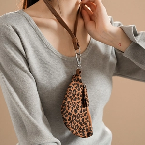 Detail view of leopard print coin purse necklace with brown leather lanyard and zipper